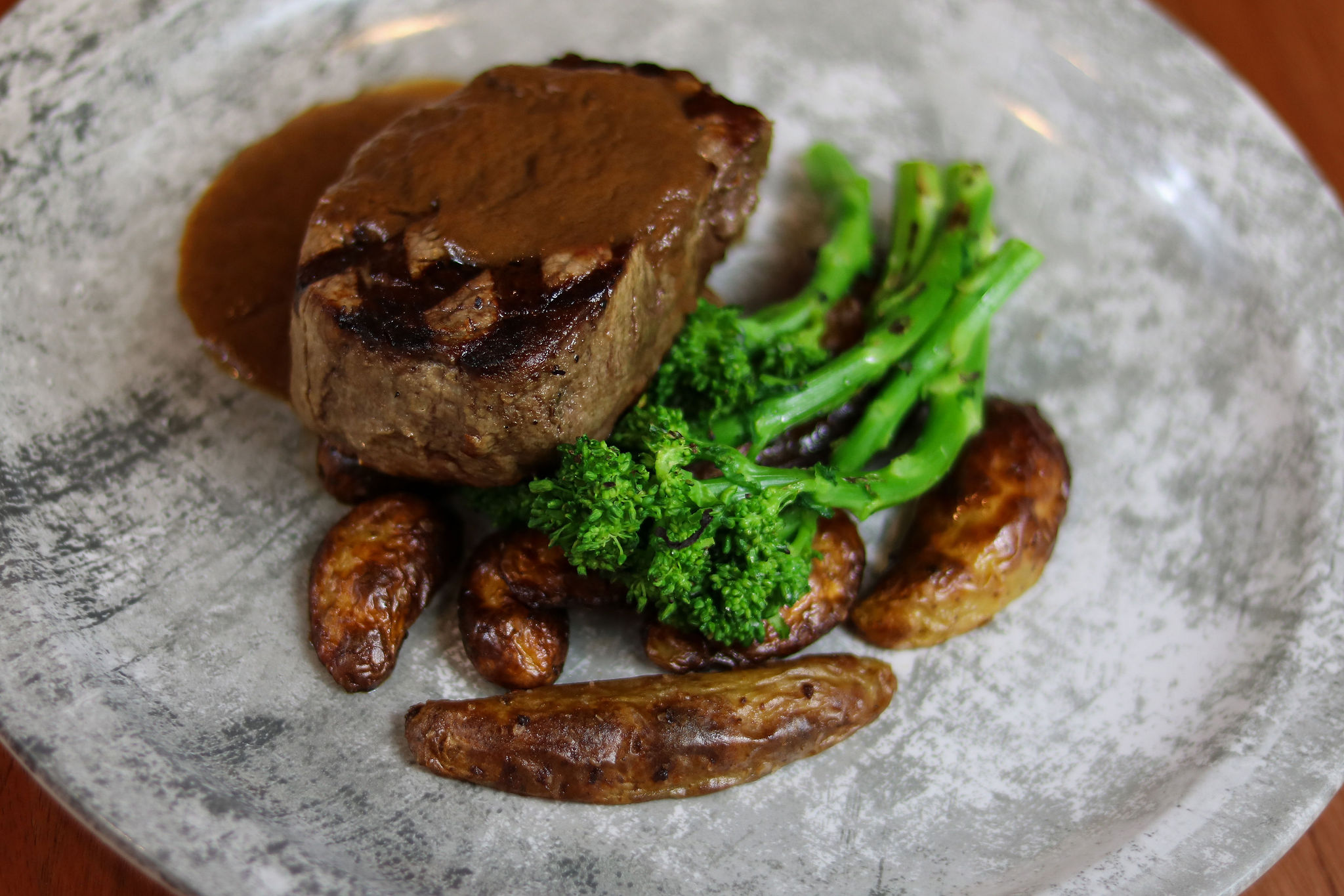 steak with sauce, fingerling potatoes and broccolini